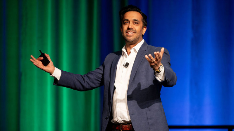 A man (Neil Pasricha) standing on stage at a podium
