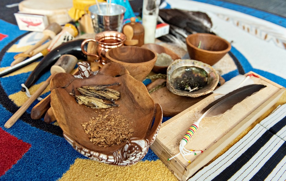 herbal medicines in shells surrounded by implements used Indigenous healing ceremonies