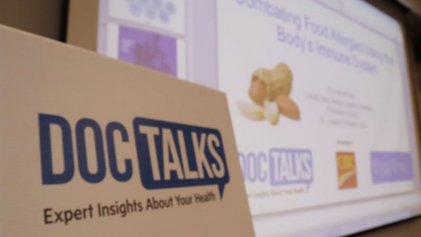 DocTalks sign in front of screen