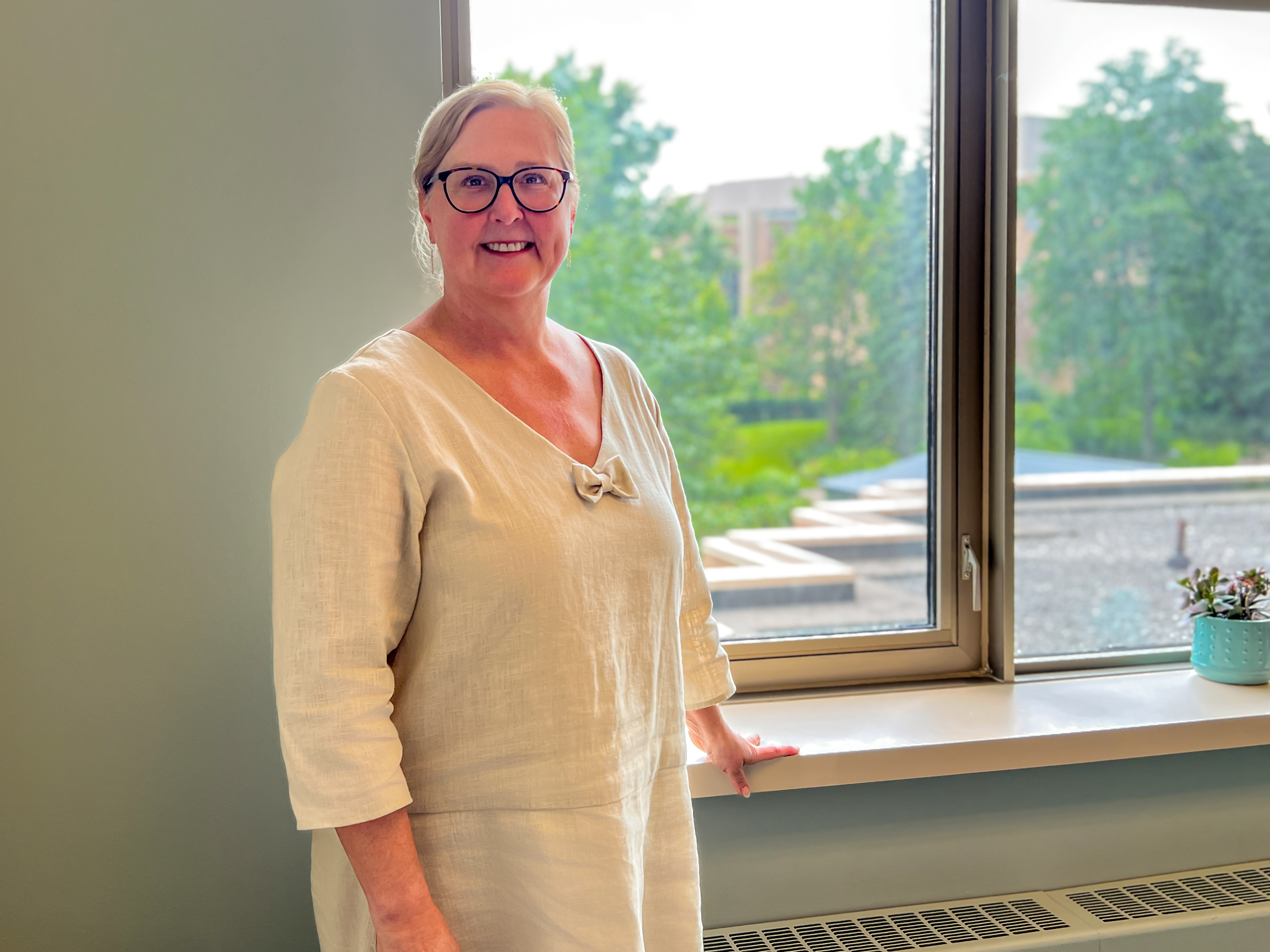 Dr. Kane in front of window