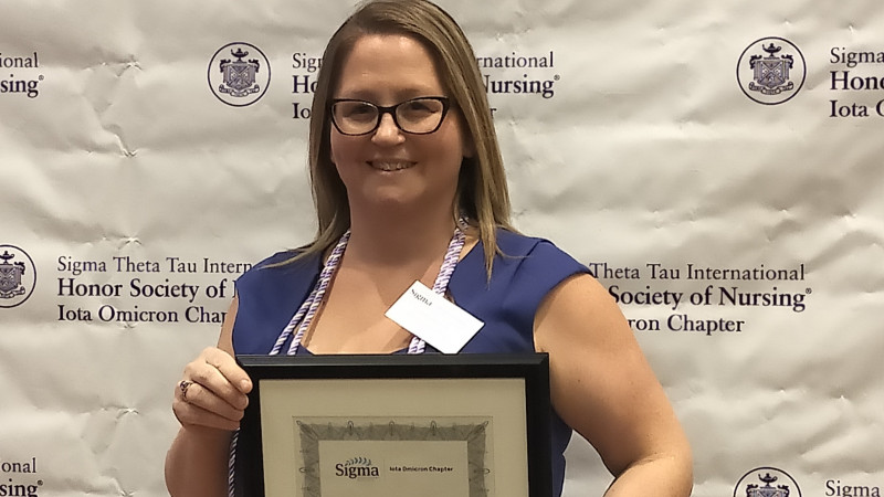 Amanda Thibeault poses for a photo with her nursing excellence award.