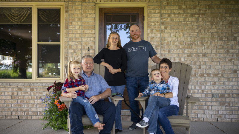Chris and Connie MacGregor and their family sitting on their porch