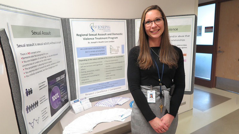 Cassandra Fisher standing in front of a display board at Western