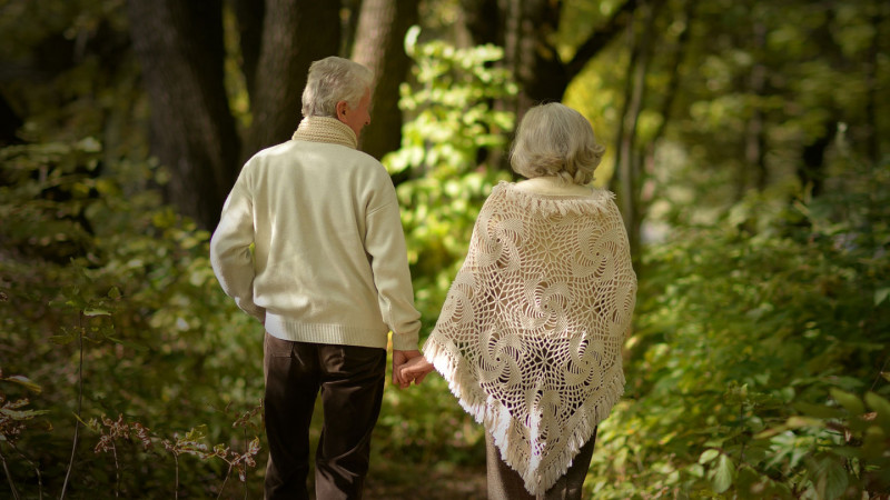 older couple walking through the woods