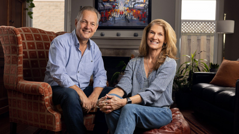 Paul and Kim Spriet sitting together on a couch