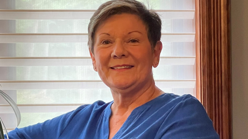 Helen Berner sitting on a couch