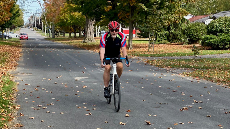 Louis Martin cycling down the street