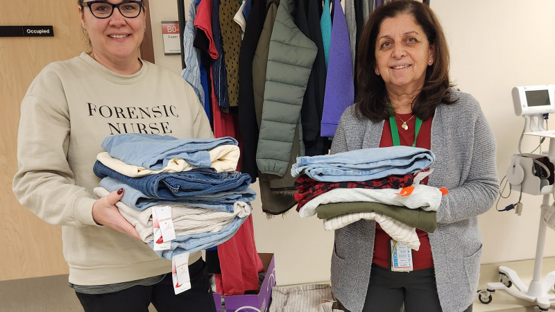 nurses holding donated clothing for sexual assault victims
