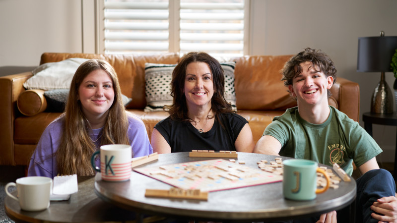 a young mother and her children sitting at a table