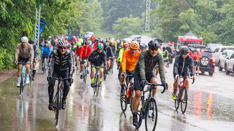 a group of cyclists in the rain