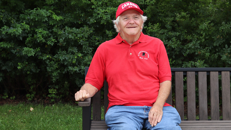 Bill Lee sitting on a bench smiling