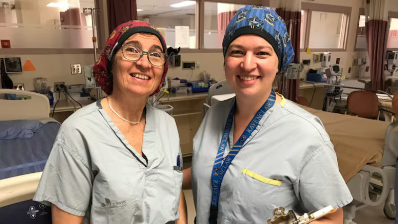 Dr. Nadeau stands with her mother in their scrubs
