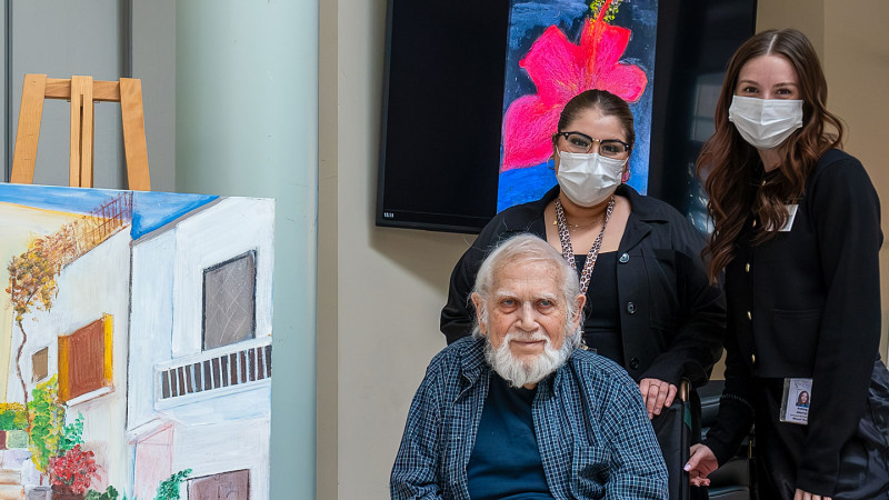 John Lartides, his art display and staff members