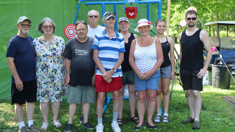 Members of the trailer park community on Lake Erie smile together on a bright sunny day