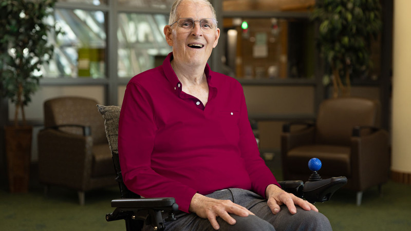 Bill sited on his wheelchair smiling