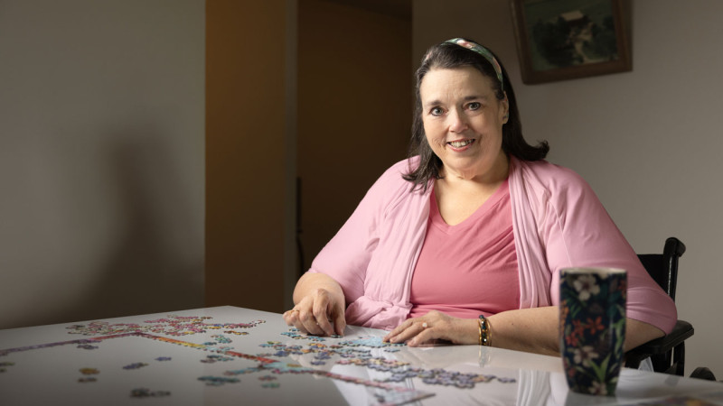 Doris is assembling a puzzle at a table