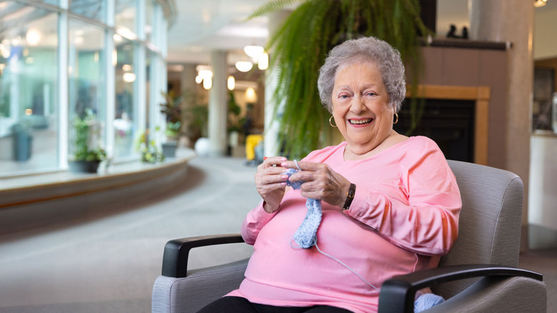 Fern McNab crocheting and smiling