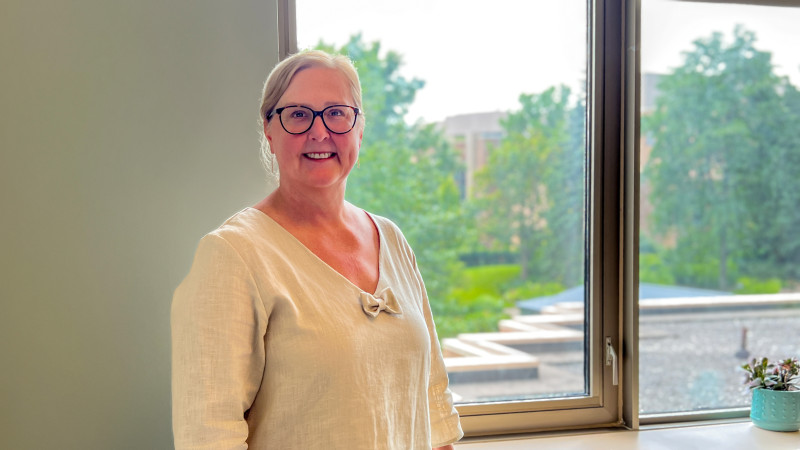 Dr. Kane standing in front of window