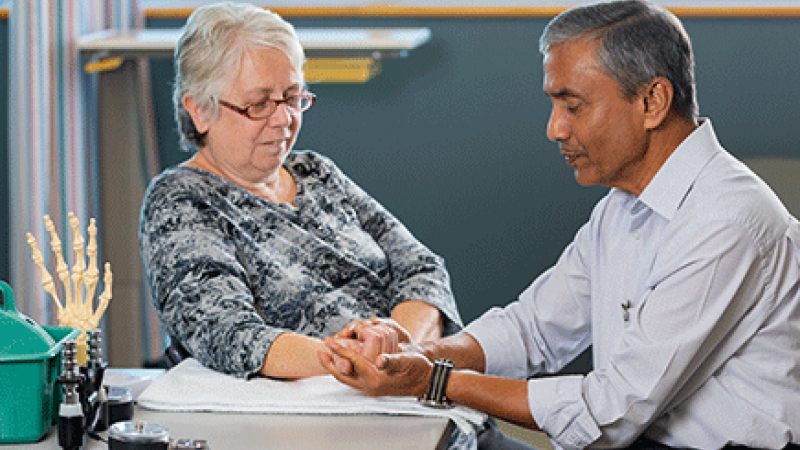 Occupation therapist Shrikant Chinchalkar treating a patient who has a hand injury