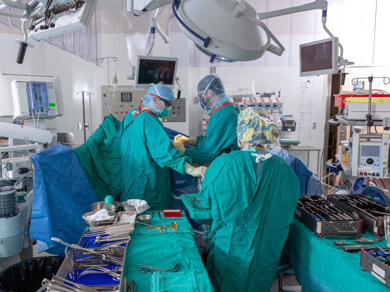 doctors perform surgery on patient in the operating room