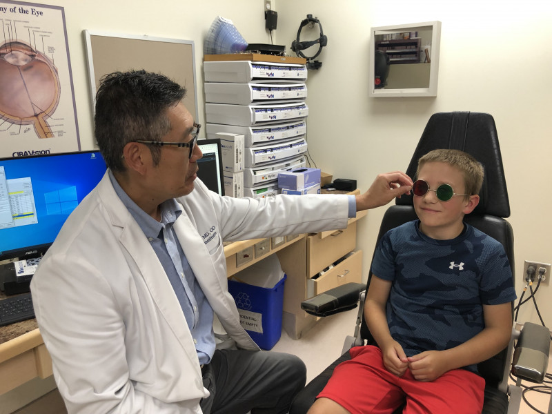 Child with Dr. Mao for eye exam