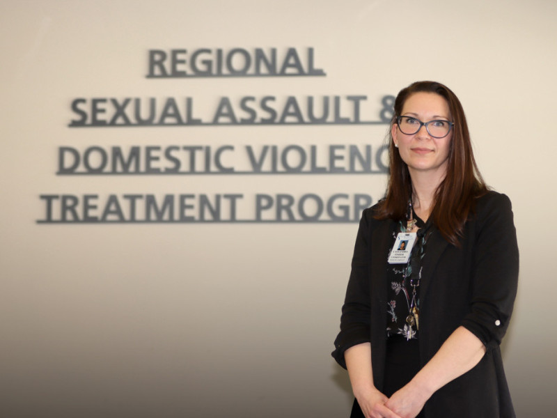 Cassie in front of sign for centre