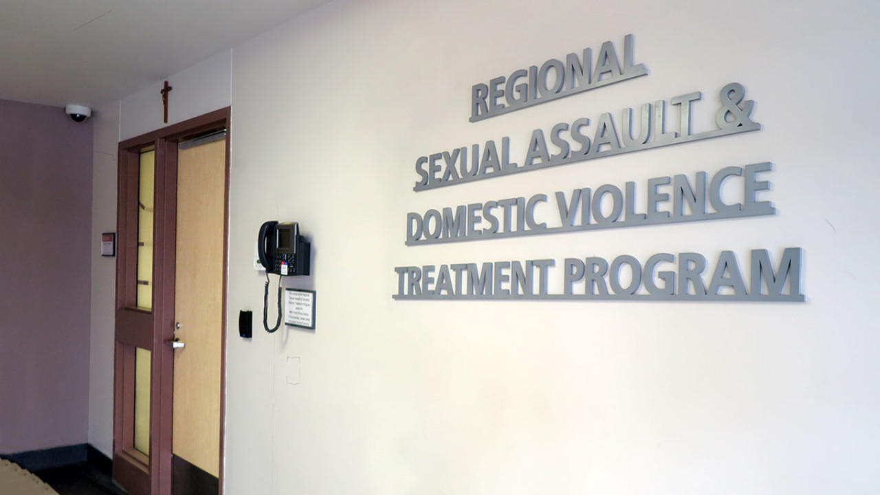 doorway and sign on the wall that reads: Regional Sexual Assault and Domestic Violence Treatment Program