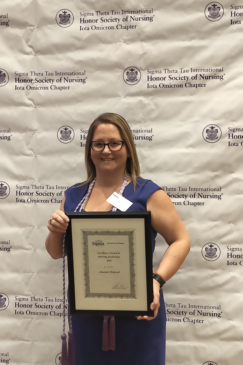 Amanda Thibeault poses for a photo with her nursing excellence award.