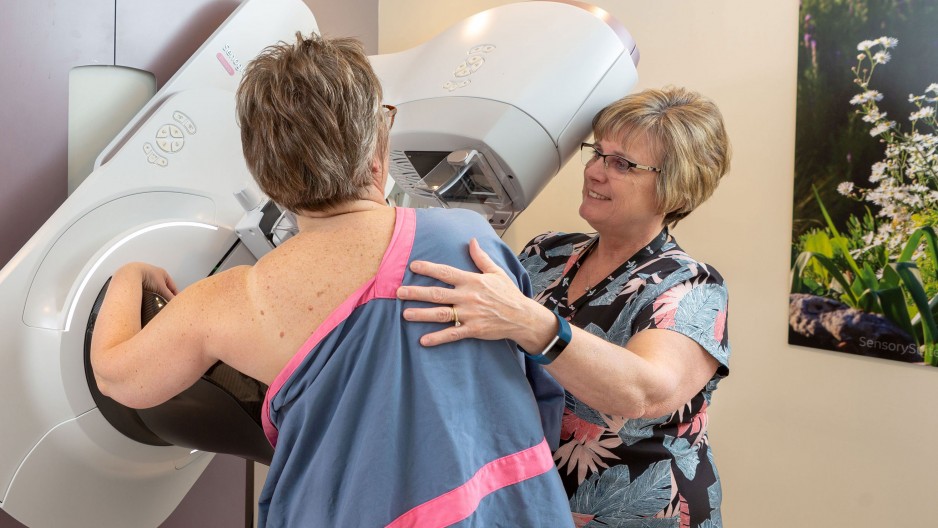 nurse gives patient a mammogram
