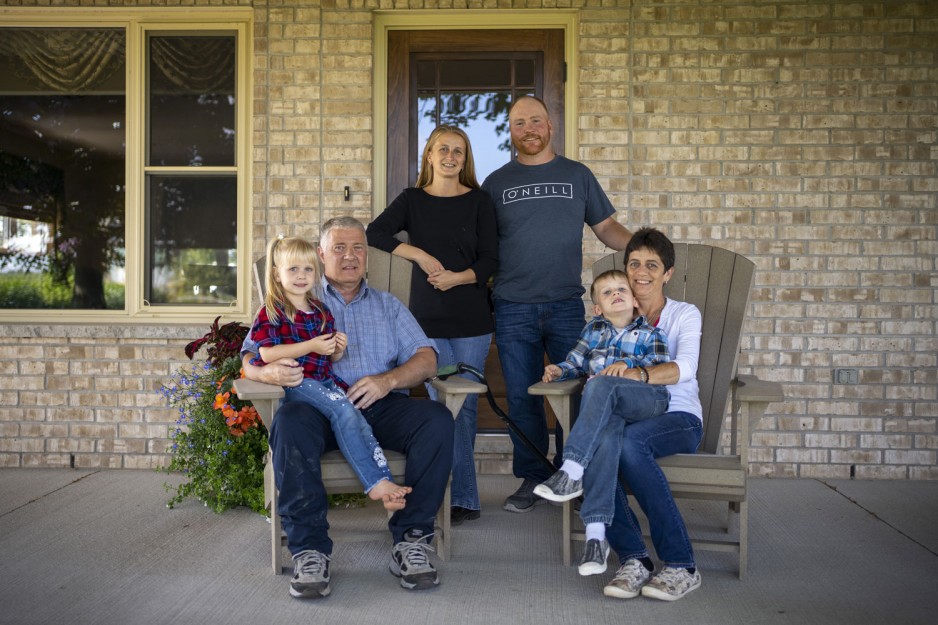 Chris and Connie MacGregor and their family sitting on their porch
