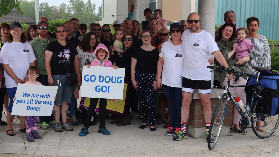 Doug Harris with a group of people under a pavilion