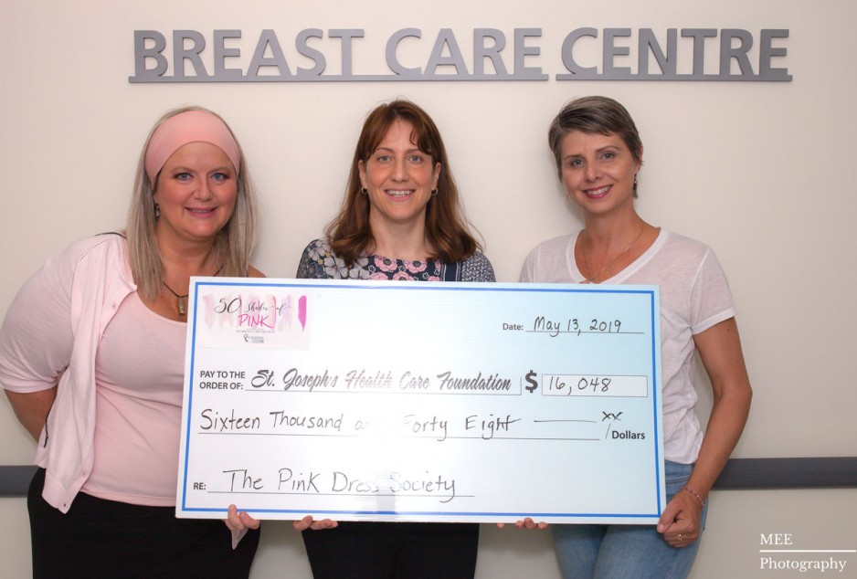 Alanna Riley, Dr. Muriel Brackstone and Christiena Healey hold up a large cheque
