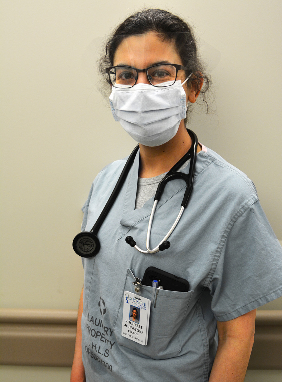 Medical resident Rochelle Johnstone wearing mask, stethoscope and surgical scrubs