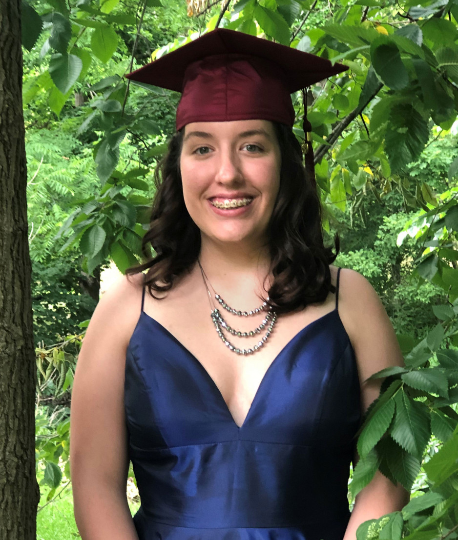 teenaged girl wearing graduation cap and blue dress