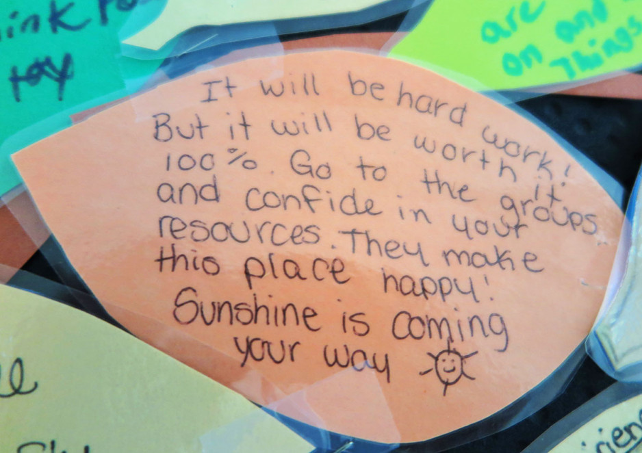 a paper leaf with a hand-written message of hope saying sunshine is coming your way