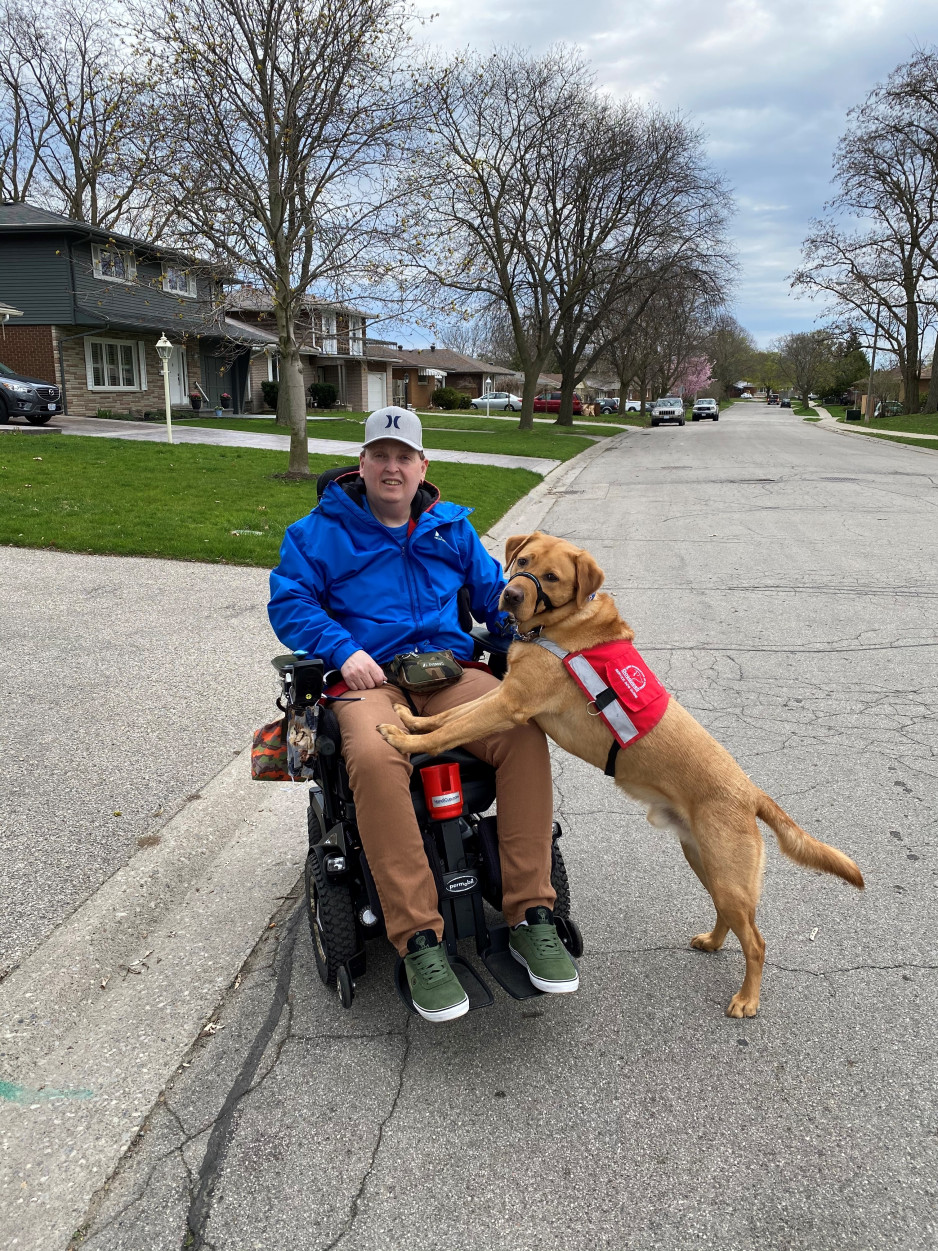 Man in wheelchair with service dog