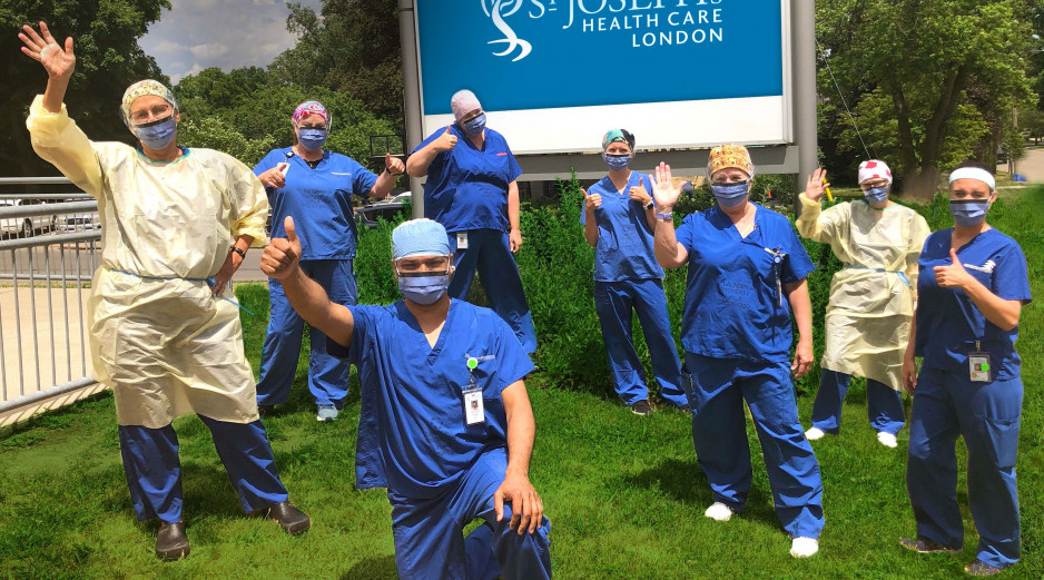 health care workers in scrubs waving outside St. Joseph's Hospital