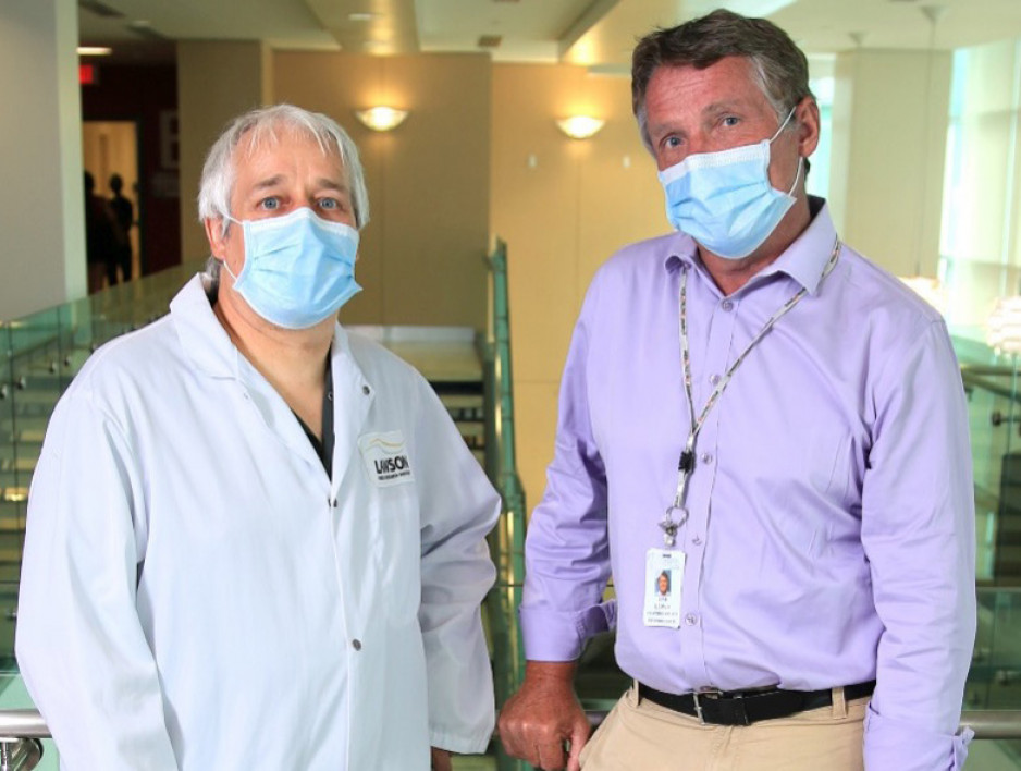 two men wearing hospital masks