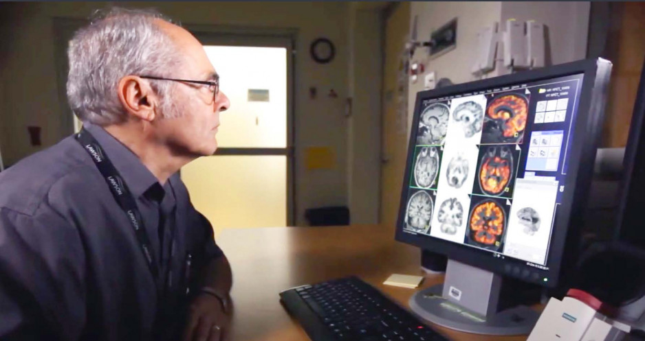 Dr. Frank Prato looks at brain images on computer screen