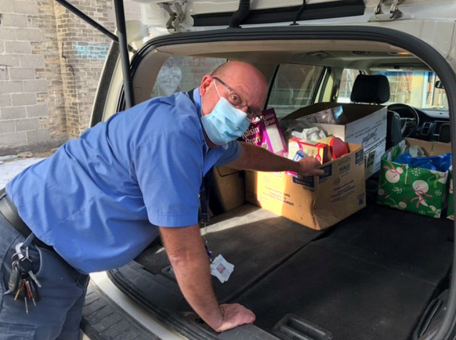 driver Rolly Willey unloading donated goods from the back of a minivan