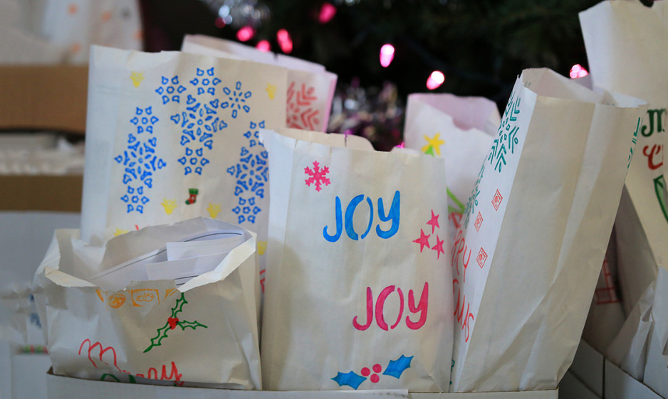 close up view of hand decorated gift bags under a Christmas tree