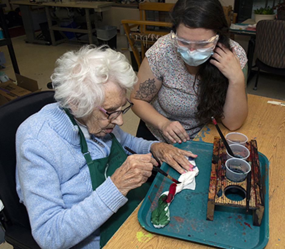 Veteran Edith Street working with art instructor Rachel Woolmore-Goodwin on a special piece of artwork