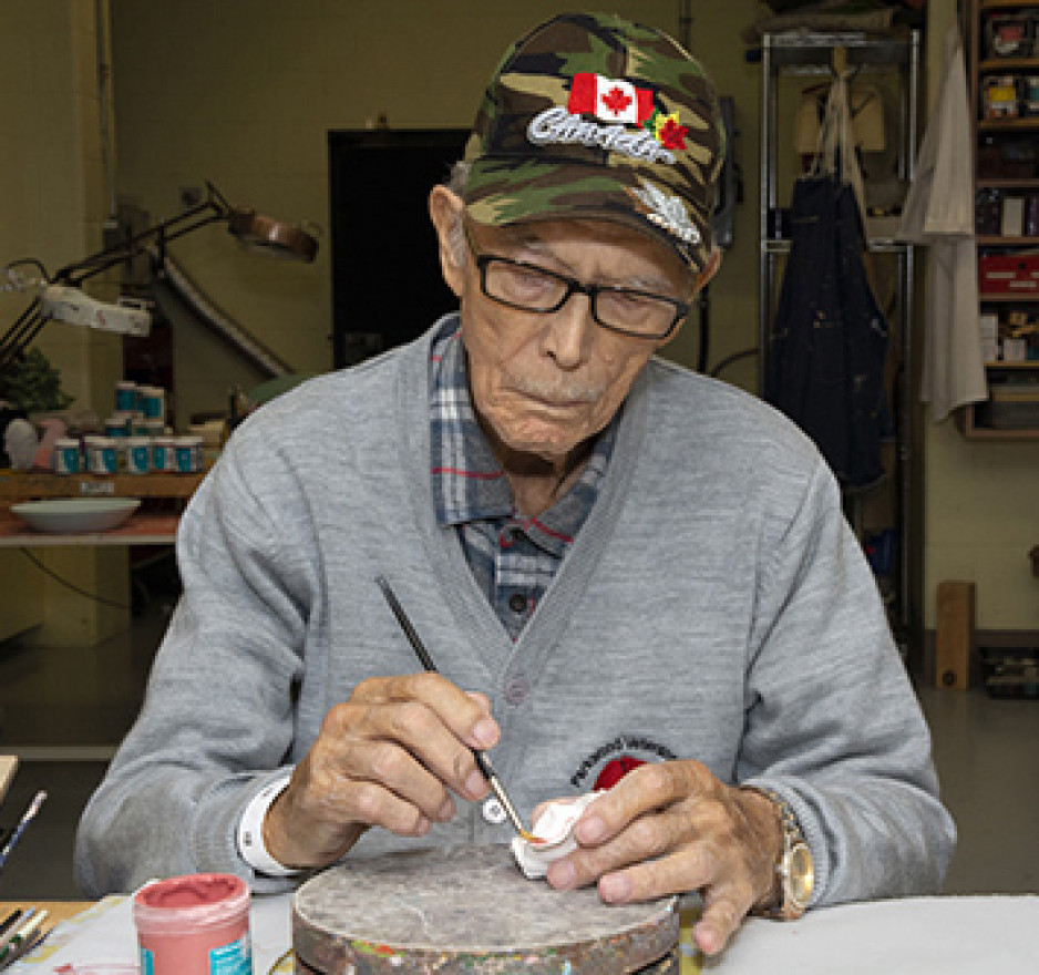 Veteran Wilson “Rocky” Rockwood paints a ceramic piece of artwork