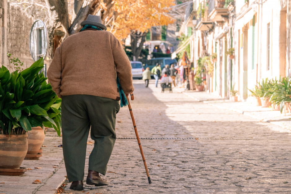 elderly man walking with cane