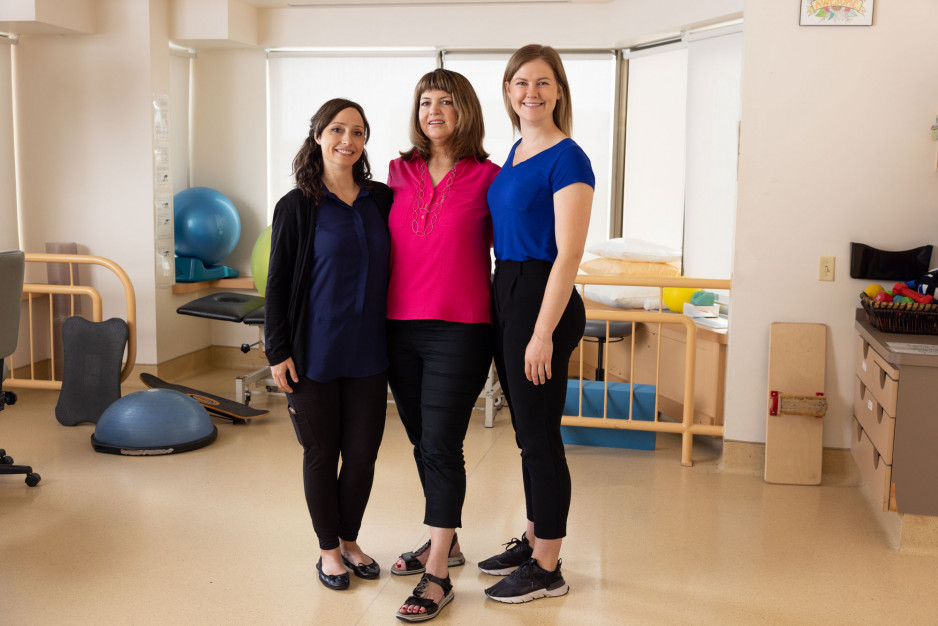 three women standing together in gym