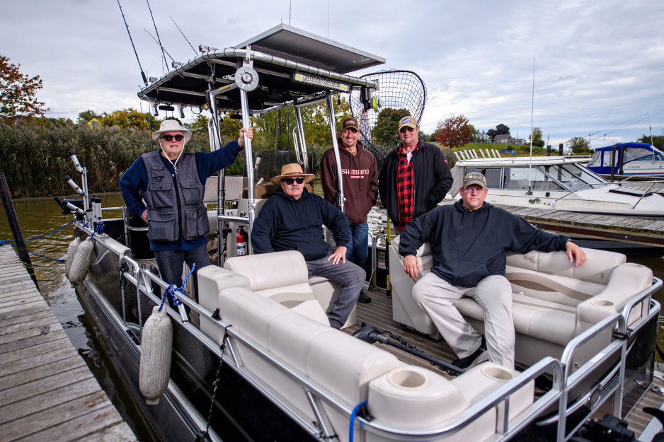 group fishing standing on boat