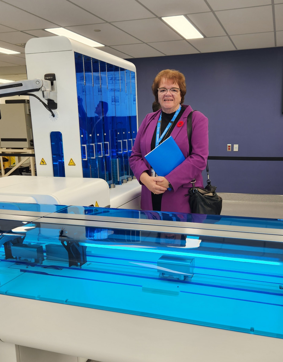 Karen Perkin with the Total Laboratory Automation system