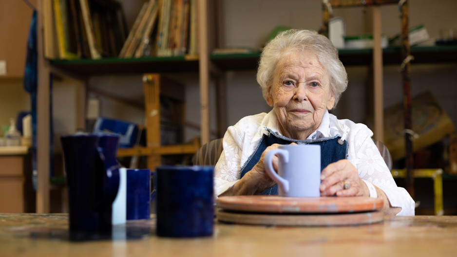 Helen Anderson holds a mug in the Veterans arts and crafts room