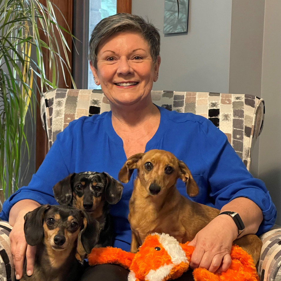 Helen sitting with her dogs
