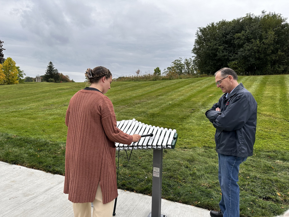 Anika Kawamura plays the xylophone with John Smibert watching